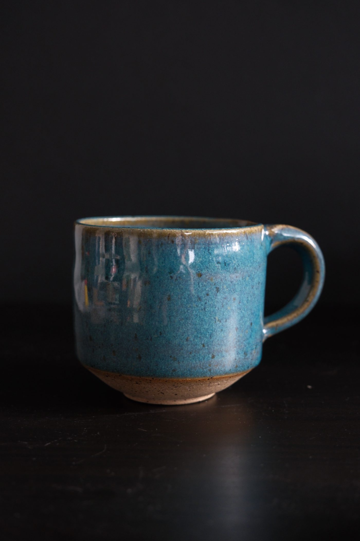 Four mugs lined up on linen