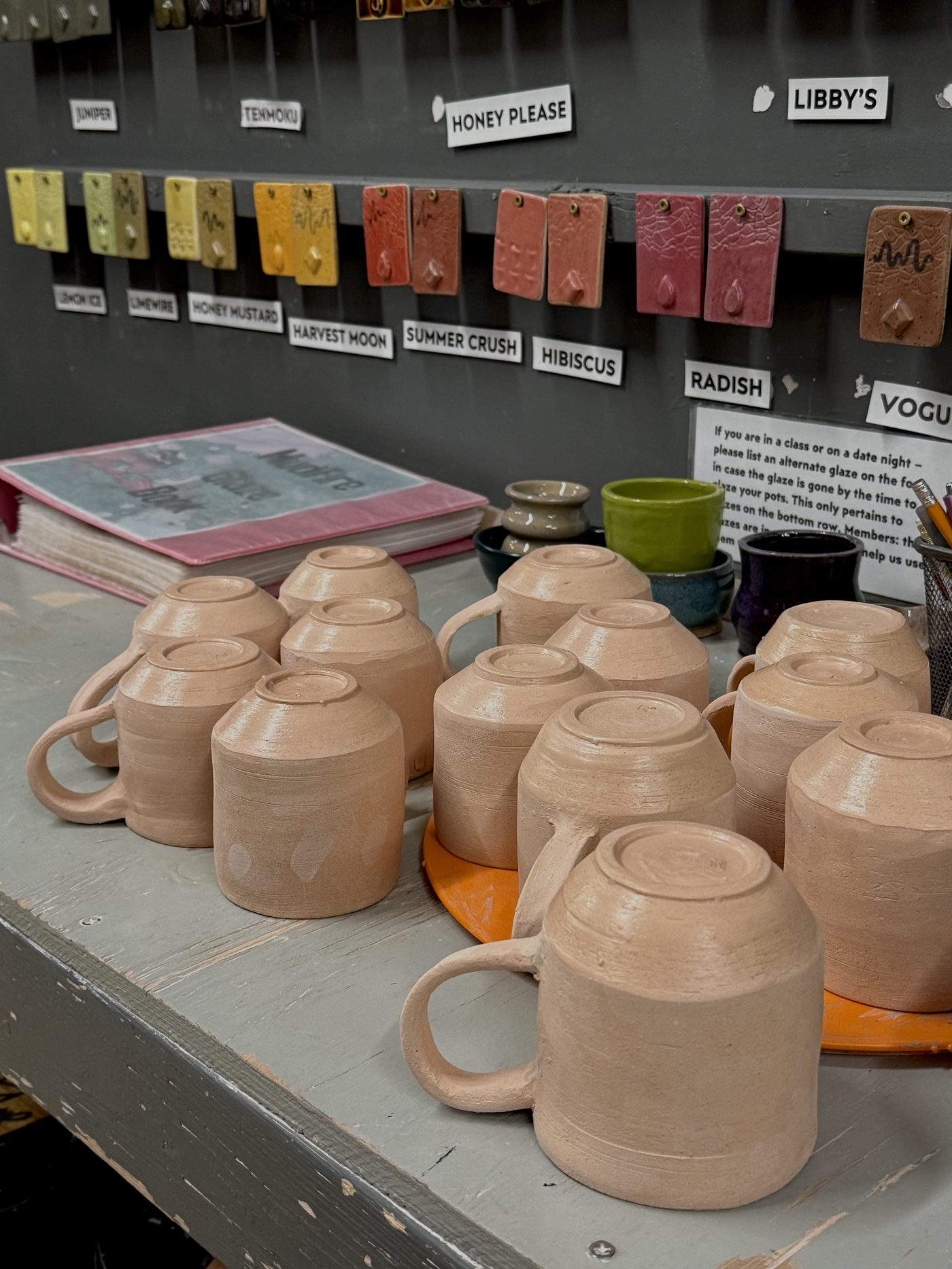 Greenware mugs drying on the studio table