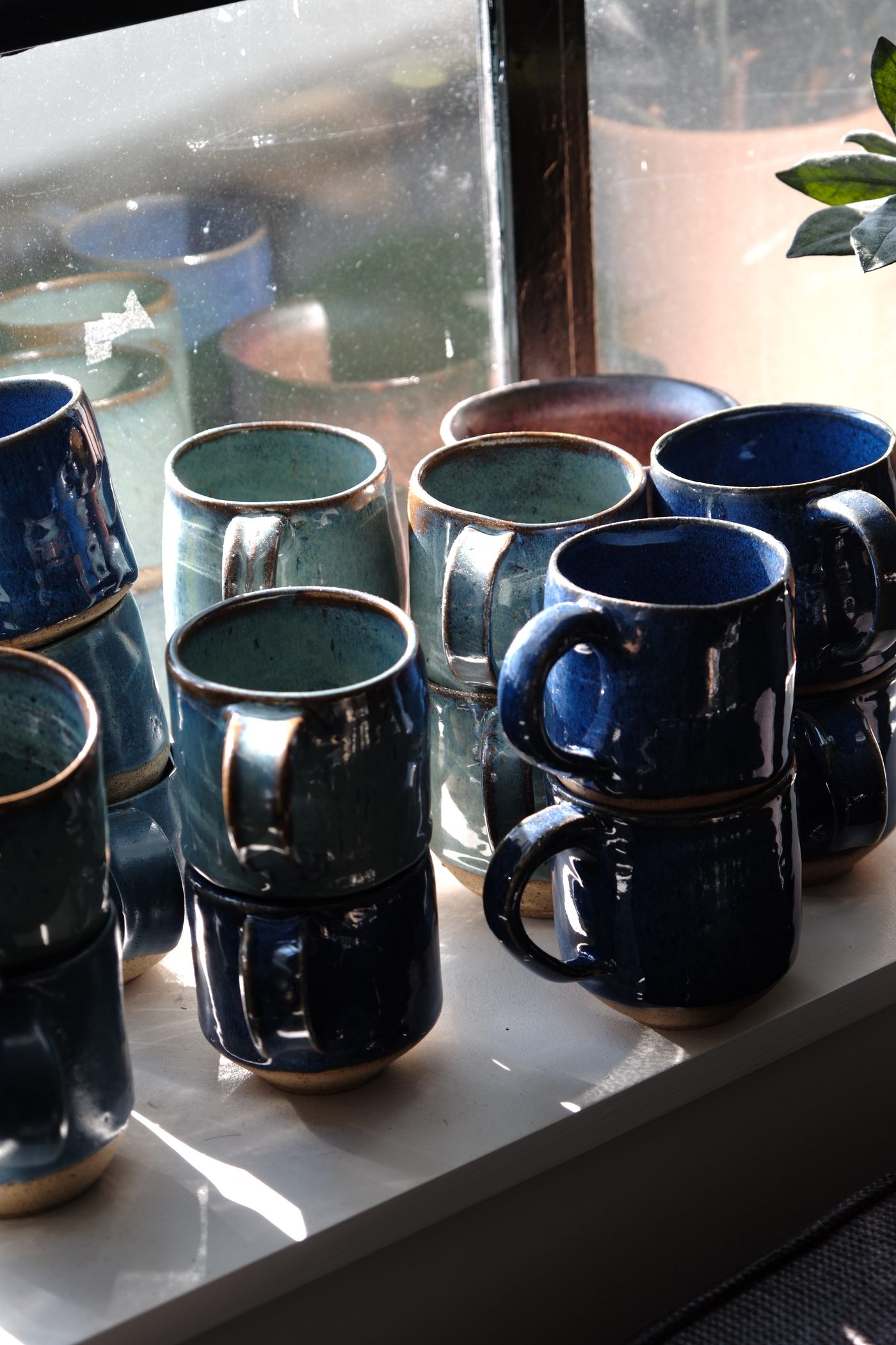 Blue mugs in window light